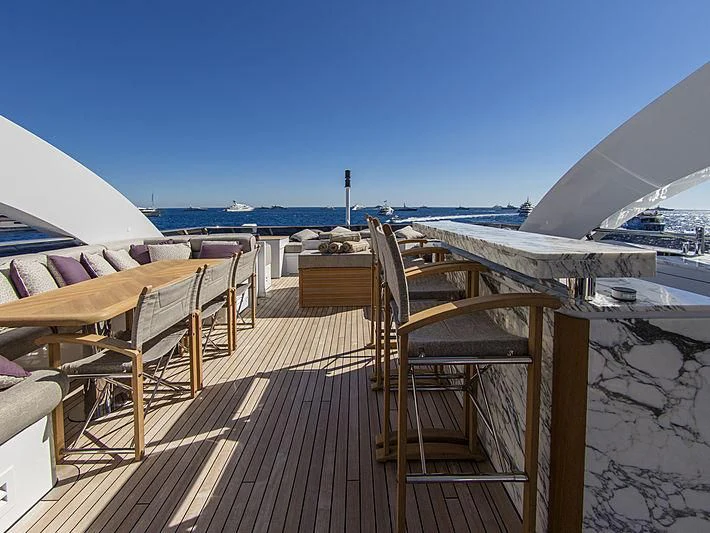 a deck with chairs and umbrellas aboard SHARKFINN Yacht for Sale