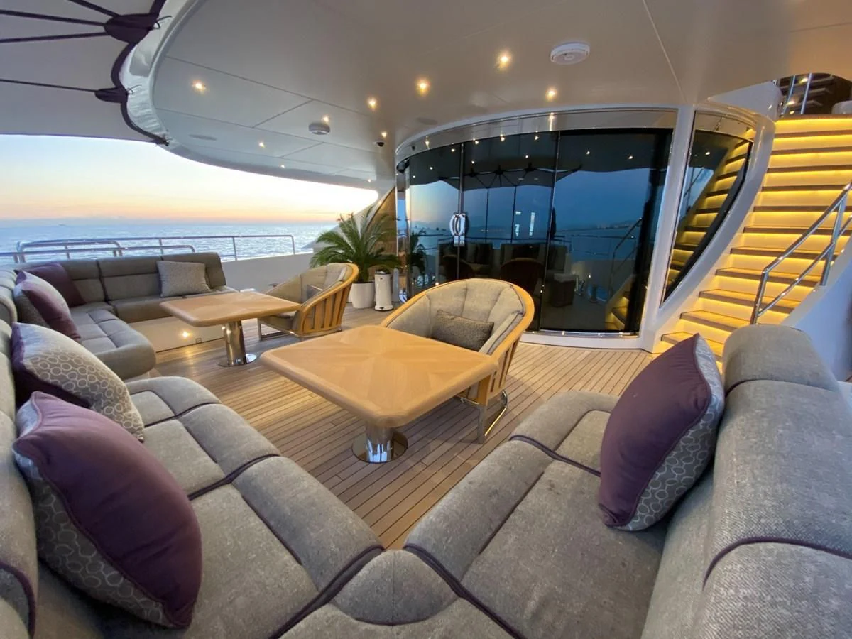 a living room with a sliding glass door aboard SHARKFINN Yacht for Sale