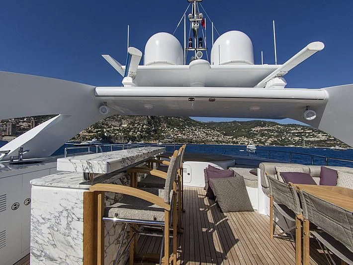 a deck with chairs and a large white aircraft on it aboard SHARKFINN Yacht for Sale