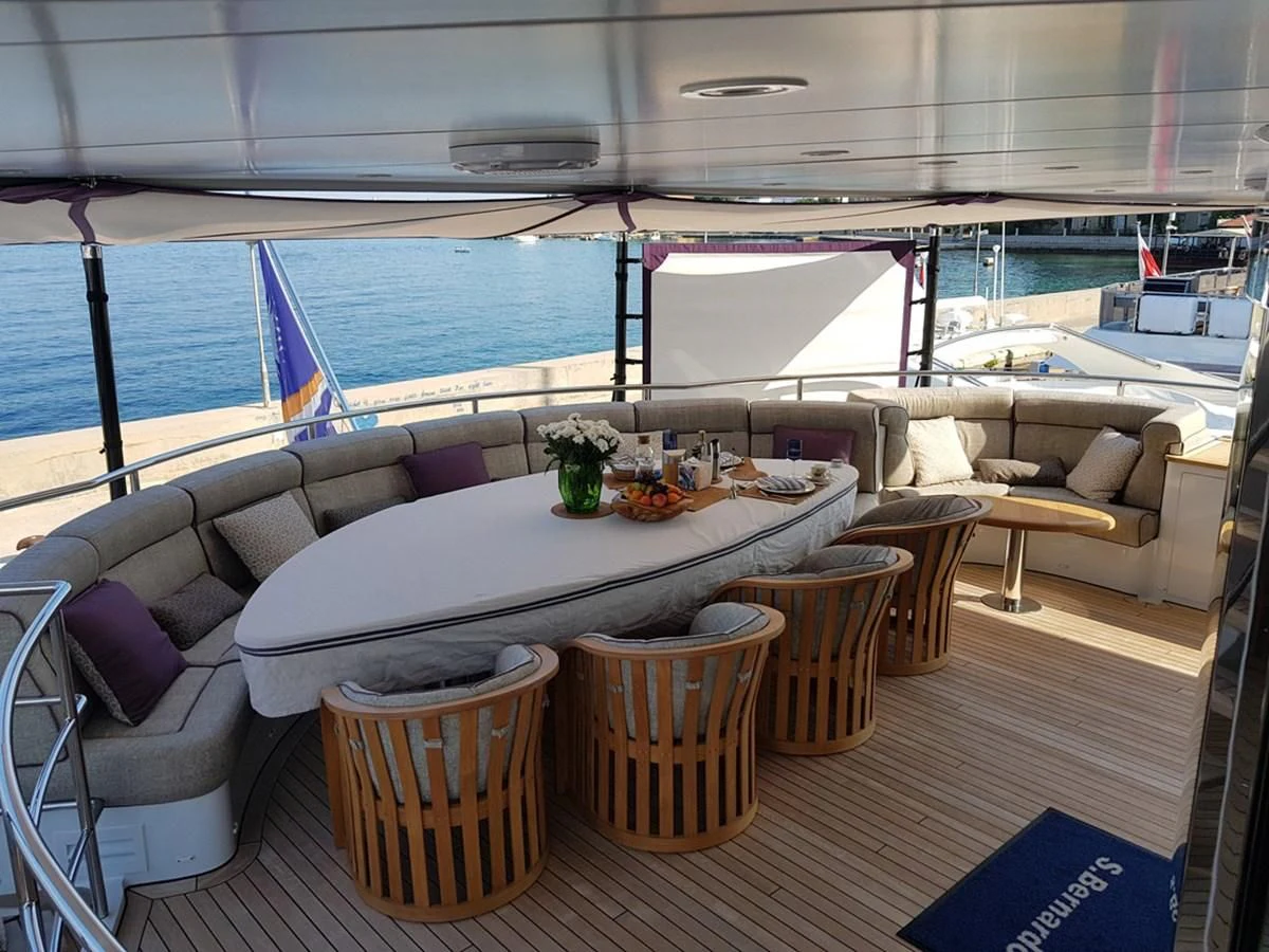 a room with a table and chairs aboard SHARKFINN Yacht for Sale
