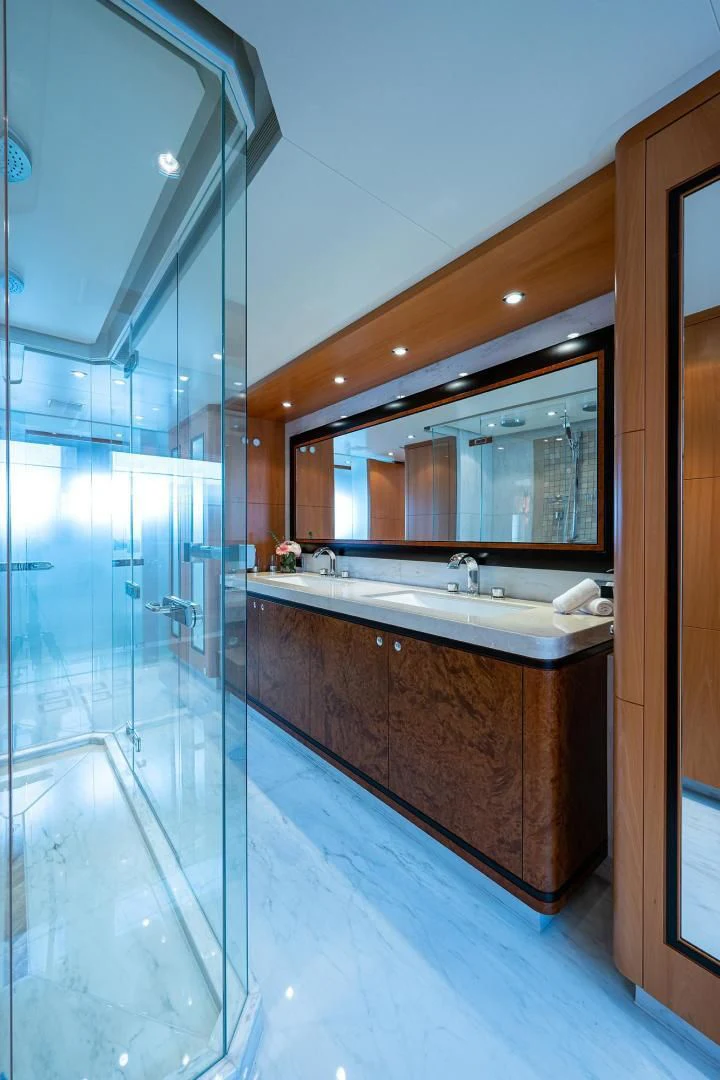 a bathroom with a glass shower aboard SHARKFINN Yacht for Sale