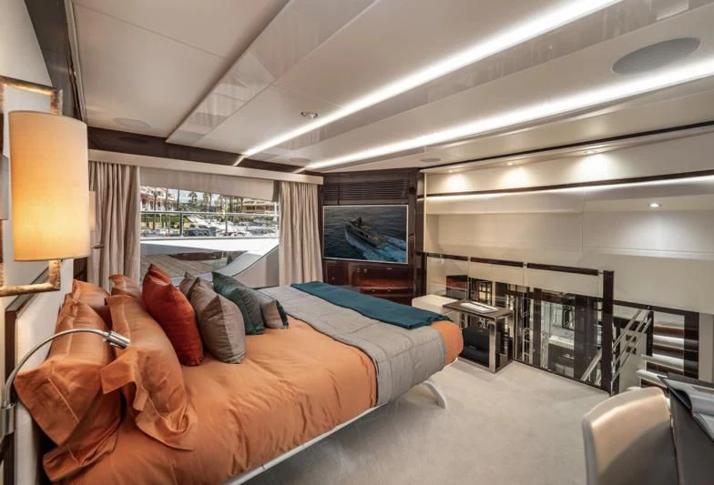 a bedroom with a bed and a tv on the wall aboard LADY M Yacht for Sale