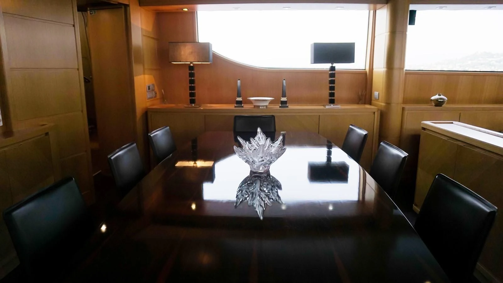 a table with chairs and a lamp aboard PETRUS Yacht for Sale