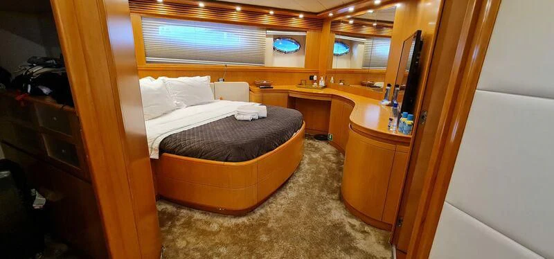 a room with a bed and desk aboard CELINE Yacht for Sale