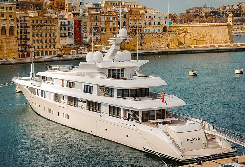 a large white boat in the water aboard PLAN B Yacht for Sale