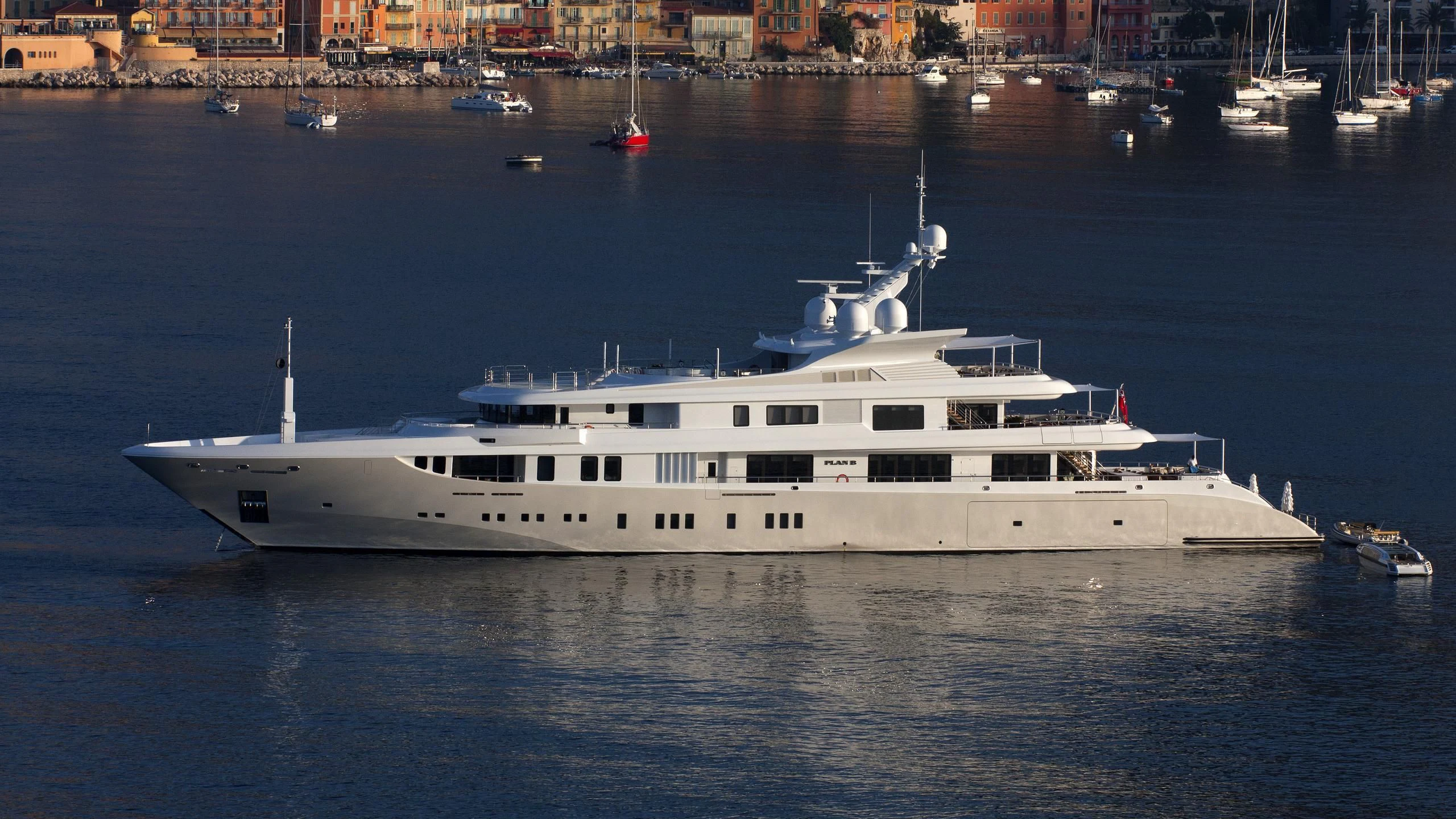 a large white yacht in the water aboard PLAN B Yacht for Sale