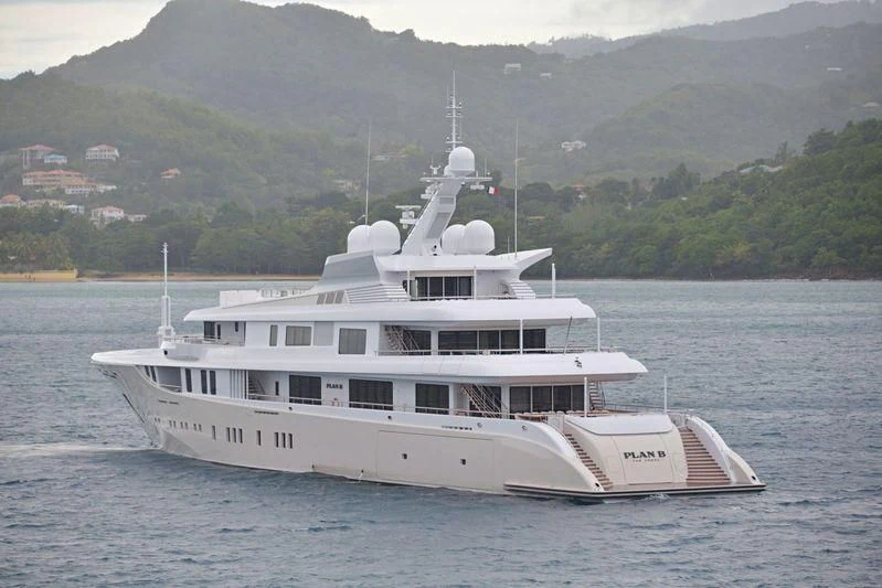 a large white boat in the water aboard PLAN B Yacht for Sale