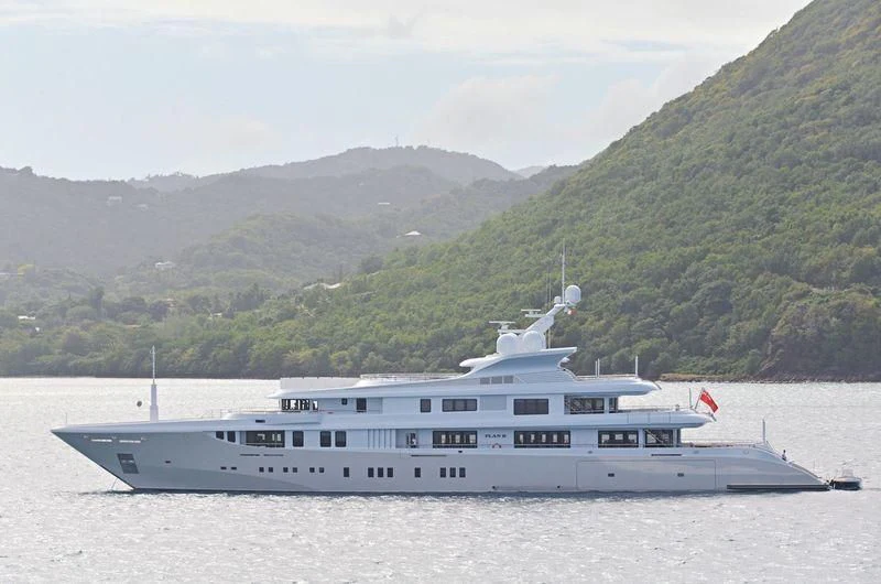 a large white boat on the water aboard PLAN B Yacht for Sale
