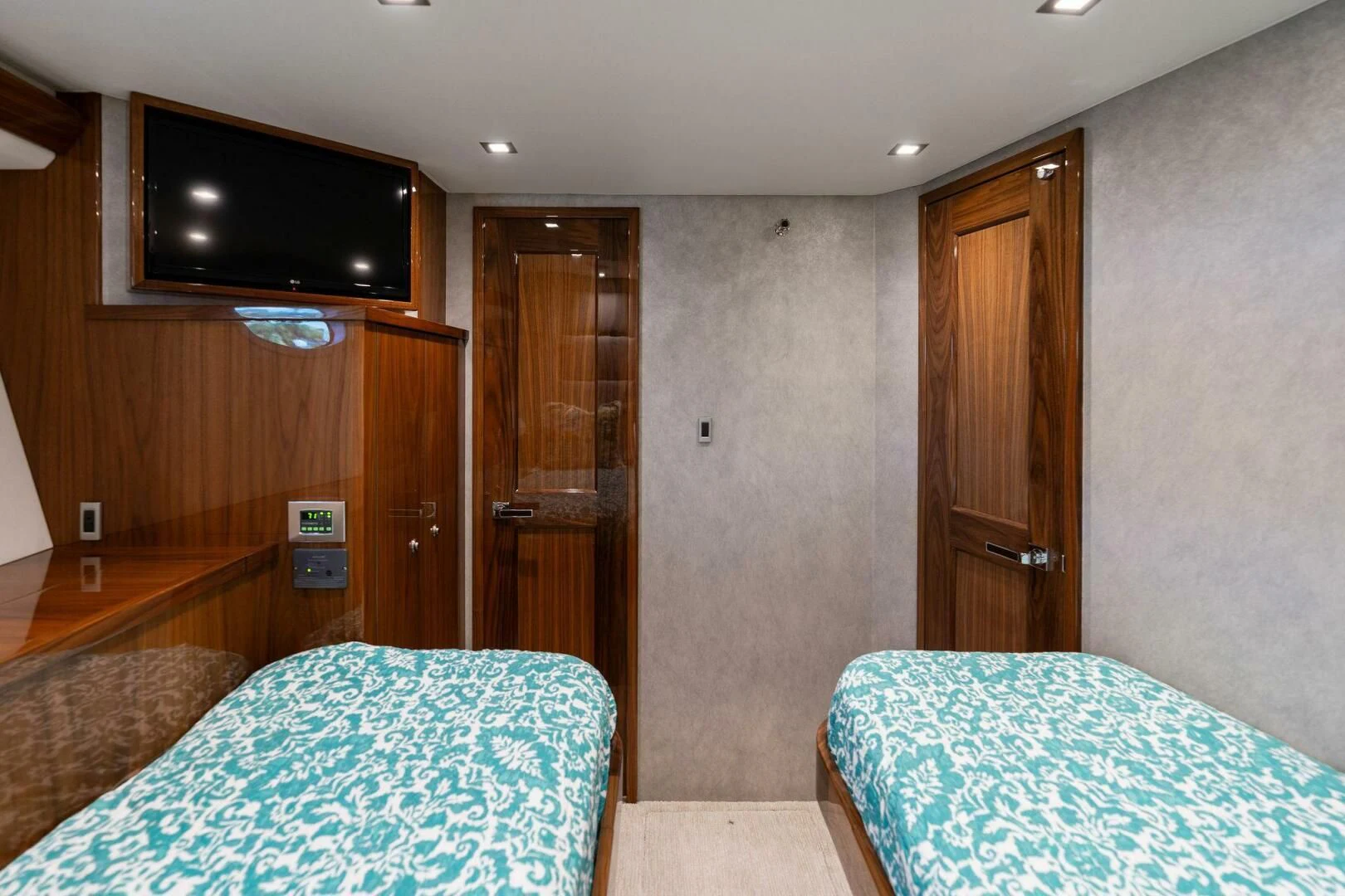 a bedroom with a bed and a television aboard MANA Yacht for Sale
