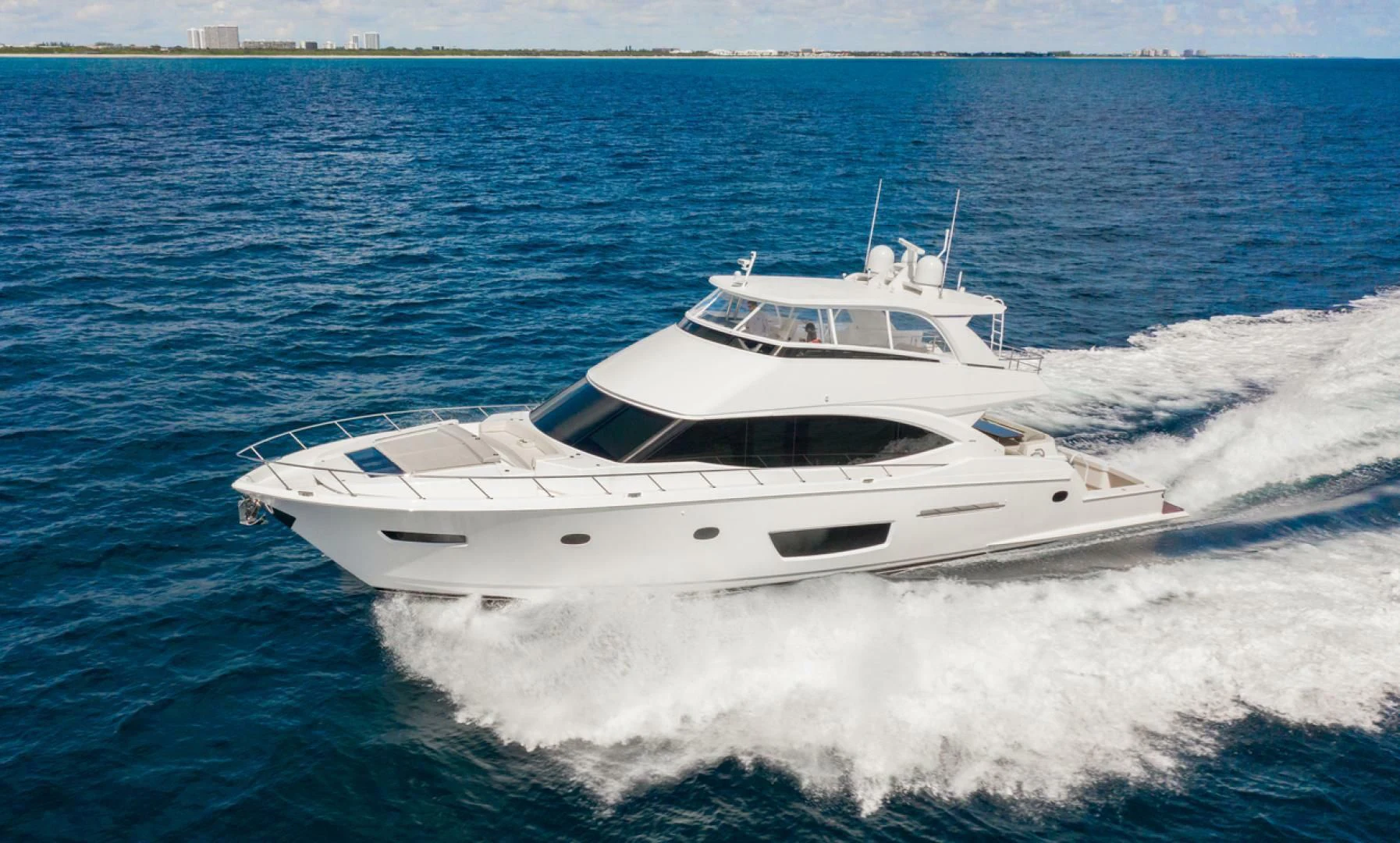 a white yacht on the water aboard MANA Yacht for Sale