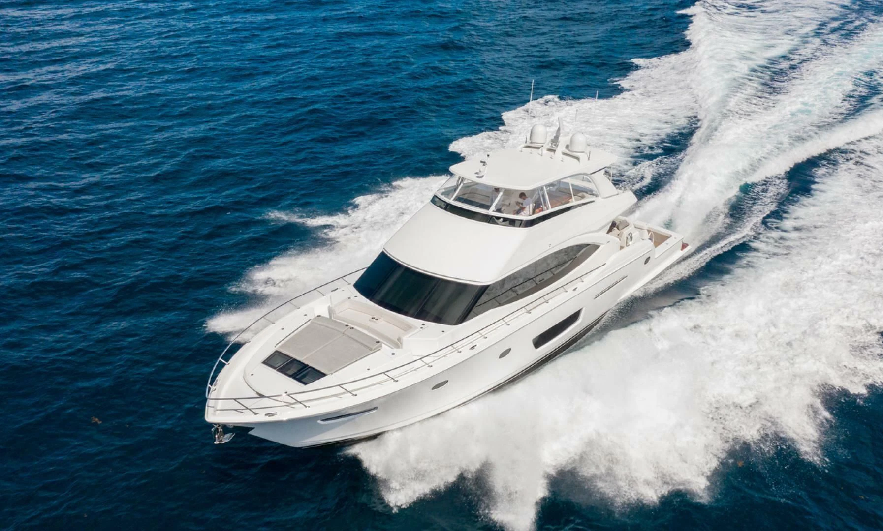 a white yacht on the water aboard MANA Yacht for Sale