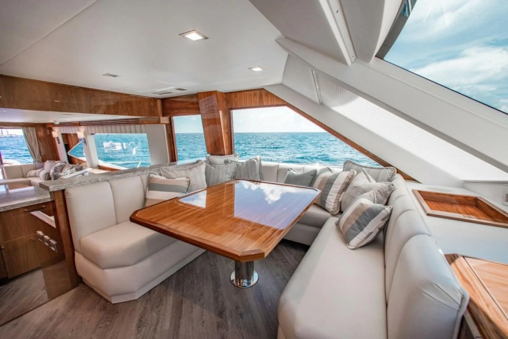 a living room with a couch and a table aboard MANA Yacht for Sale
