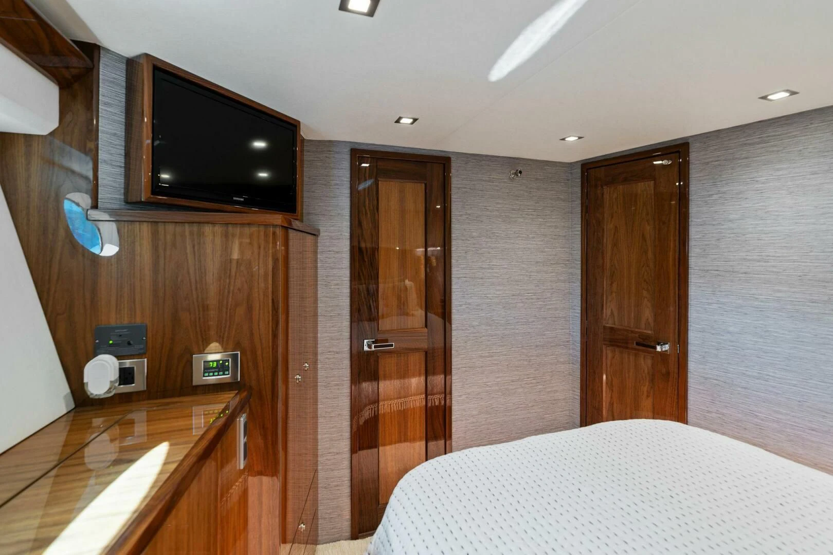 a hotel room with a television and bed aboard MANA Yacht for Sale