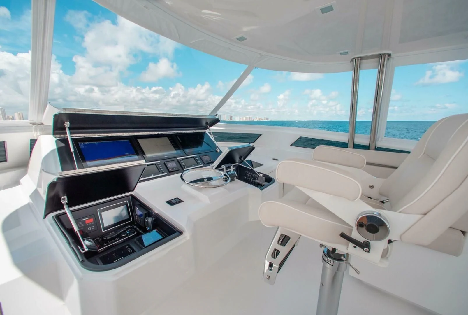 a white yacht with a black screen aboard MANA Yacht for Sale