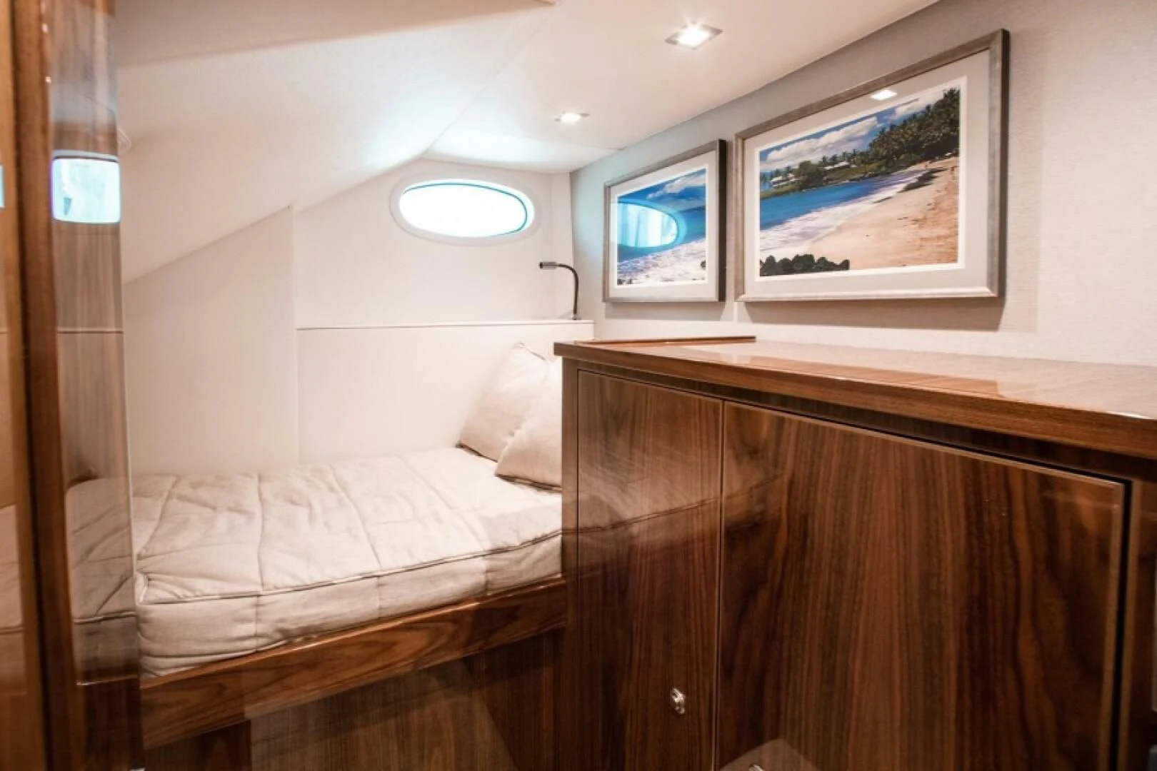 a room with a bed and a desk aboard MANA Yacht for Sale