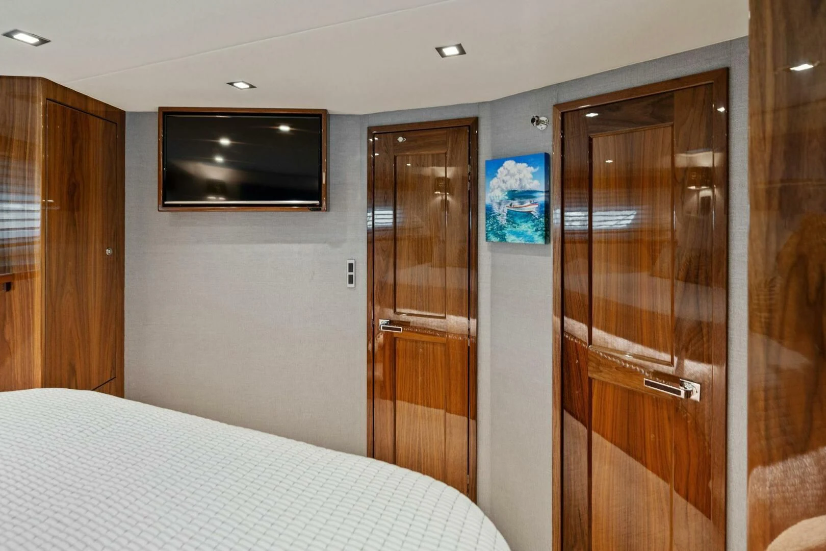 a hotel room with a bed and a television aboard MANA Yacht for Sale