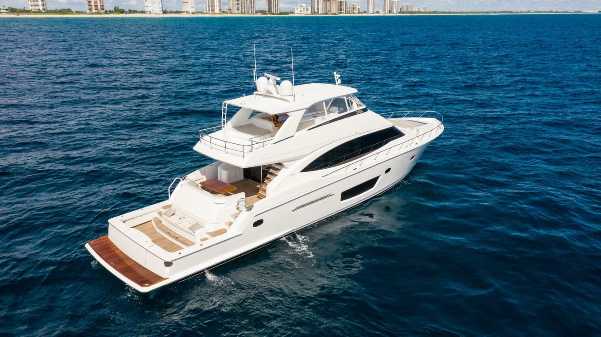 a white boat on the water aboard MANA Yacht for Sale