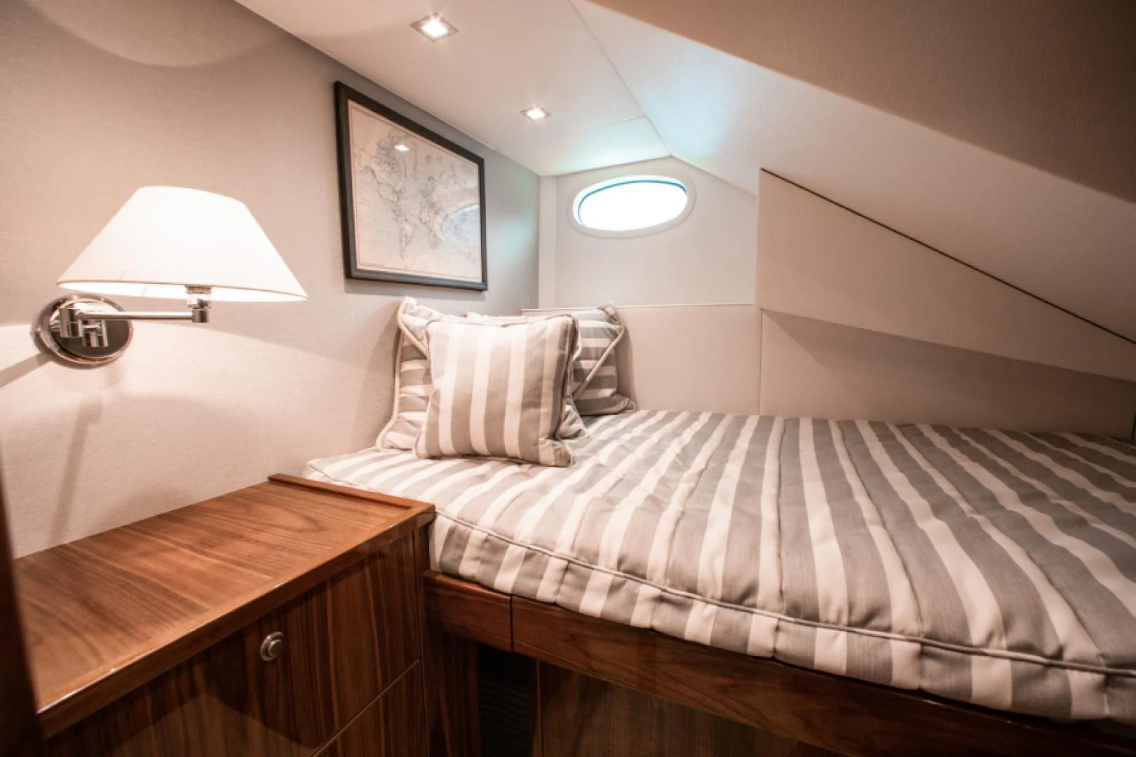a bed with a striped sheet aboard MANA Yacht for Sale