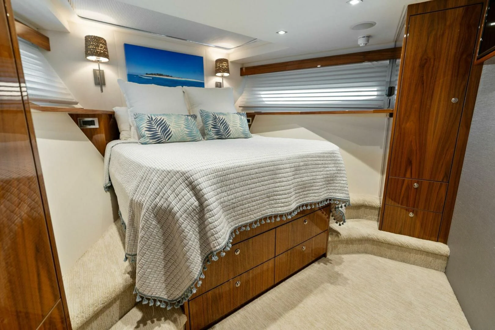 a bedroom with a bed and a wood door aboard MANA Yacht for Sale