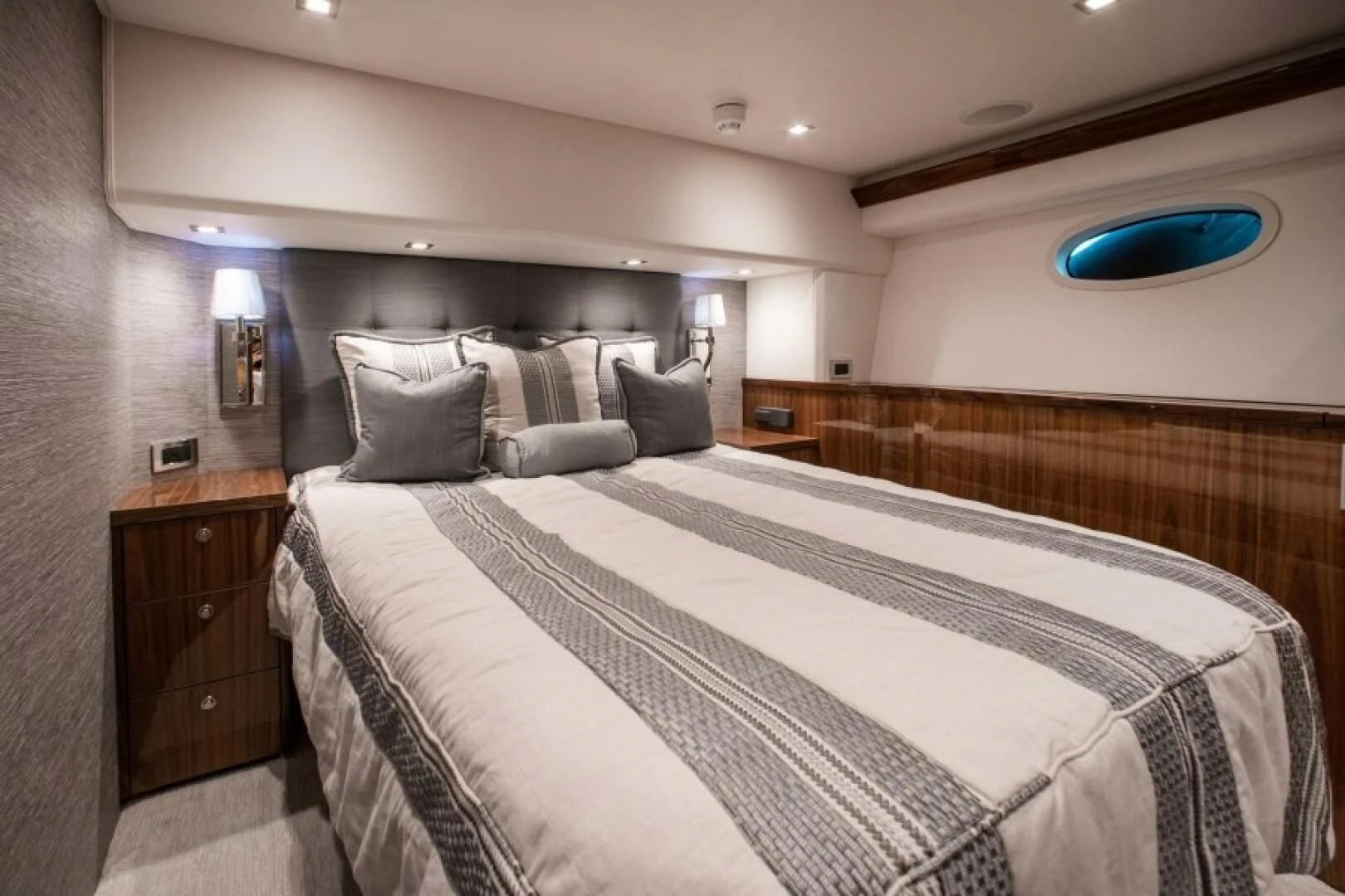 a bed with a white comforter aboard MANA Yacht for Sale