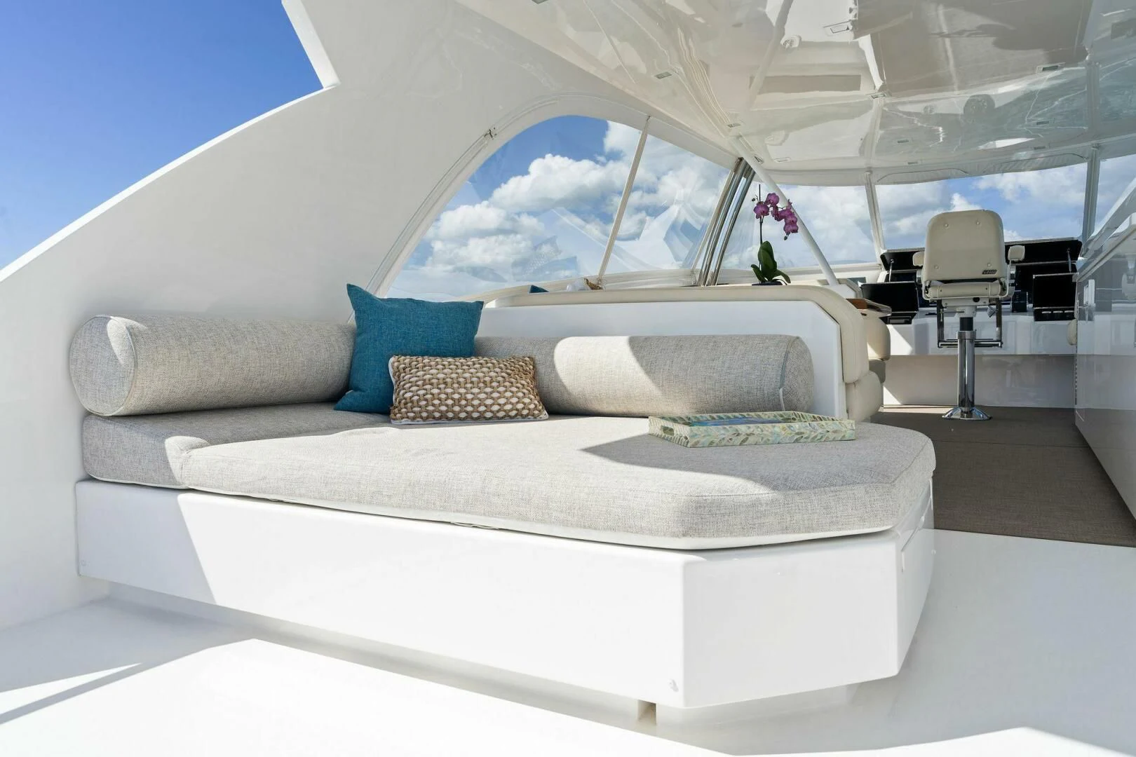 a white bed with blue pillows aboard MANA Yacht for Sale