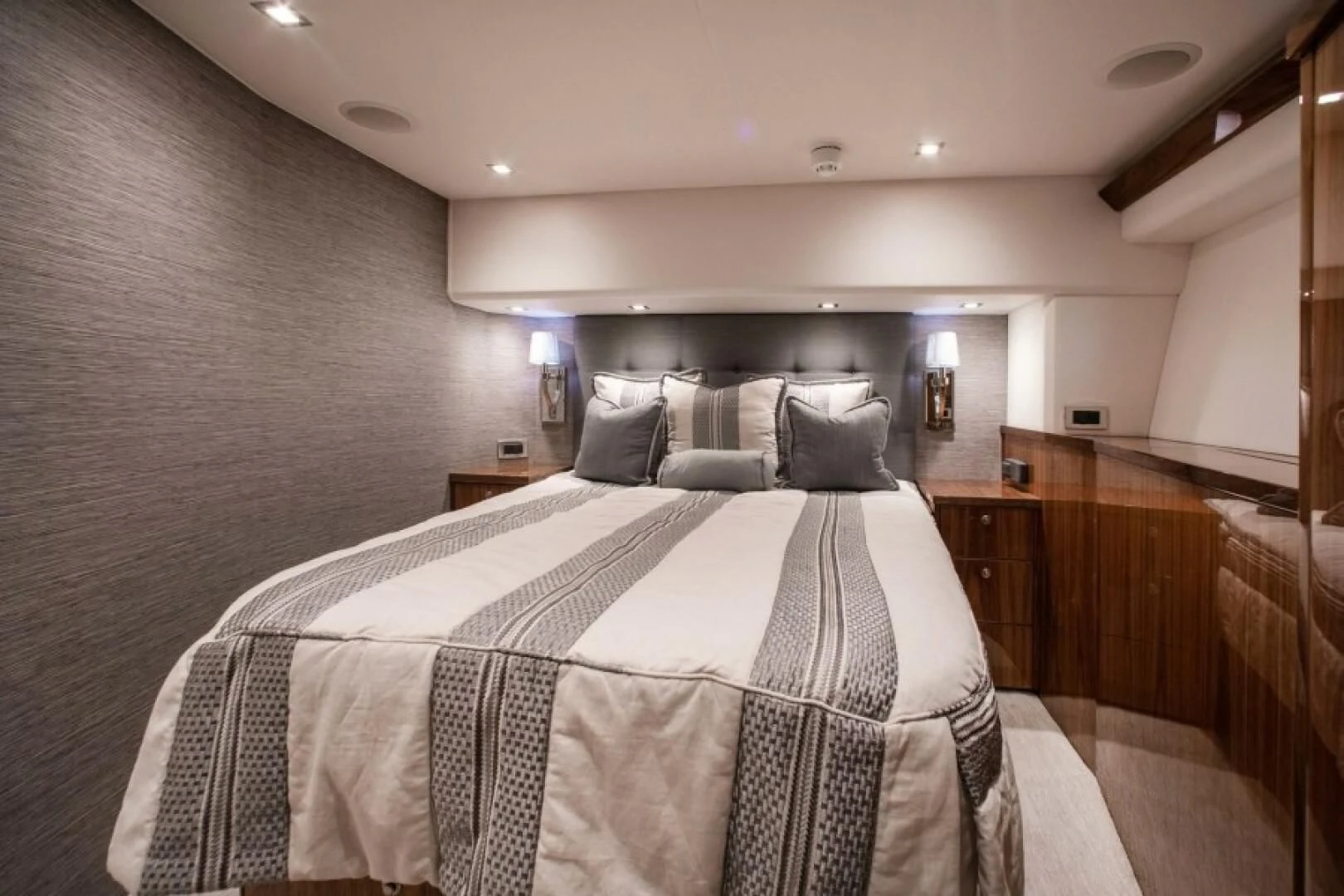 a bed with a white comforter aboard MANA Yacht for Sale