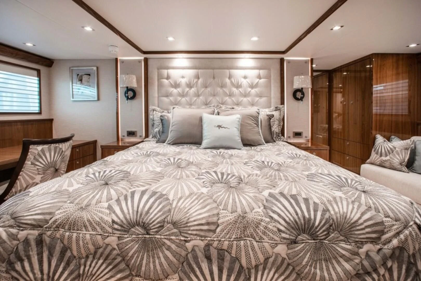 a large bed with white sheets aboard MANA Yacht for Sale