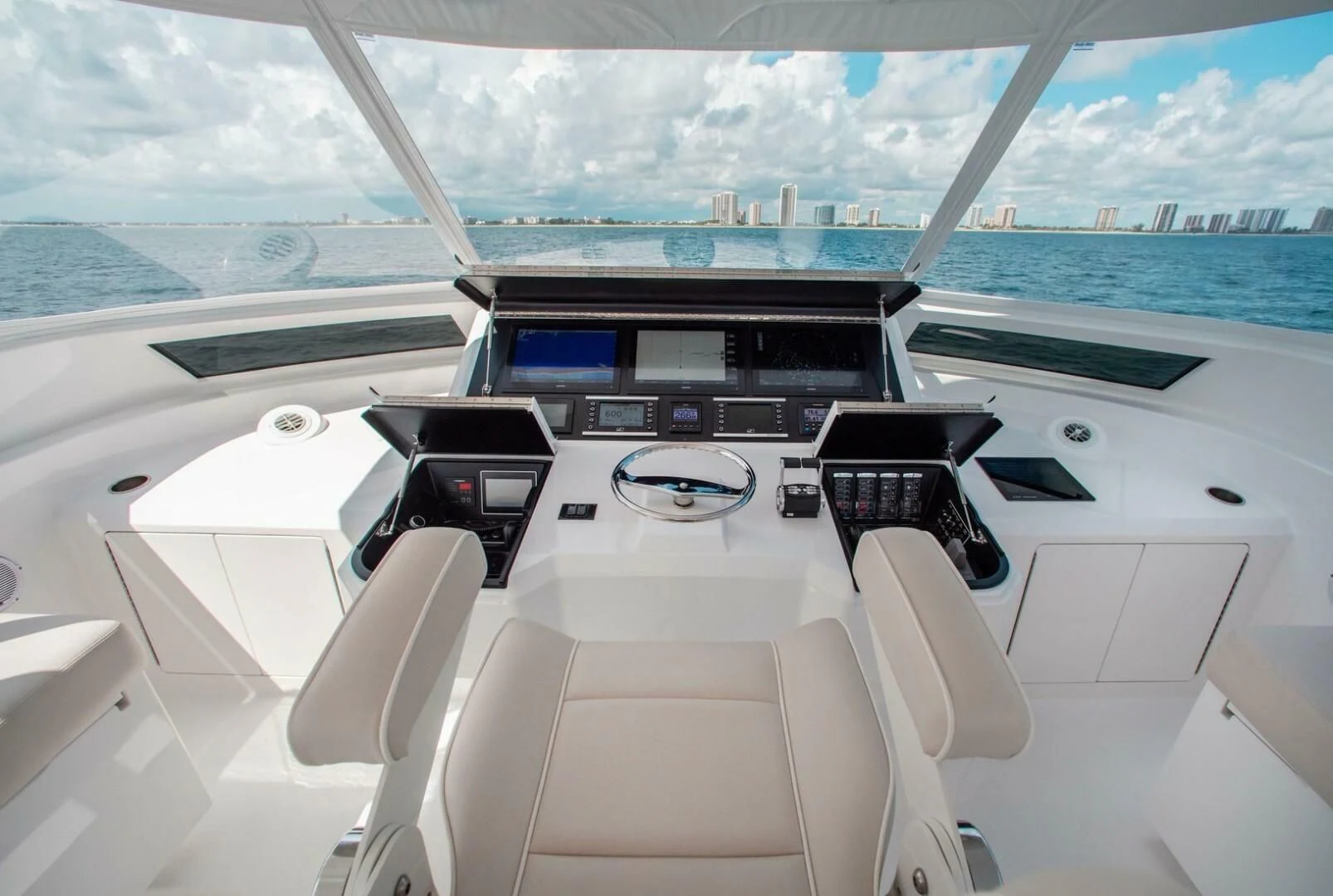 inside of a white vehicle with a large window and a view of the water aboard MANA Yacht for Sale