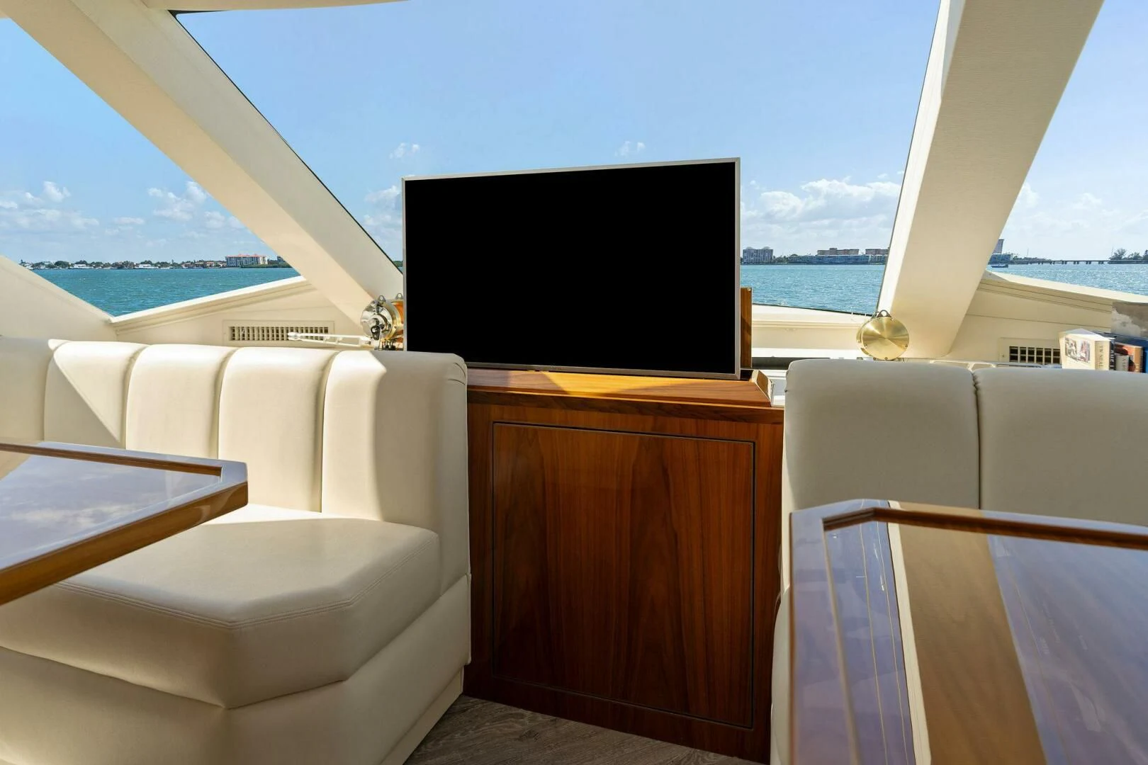 a room with a tv and a couch aboard MANA Yacht for Sale