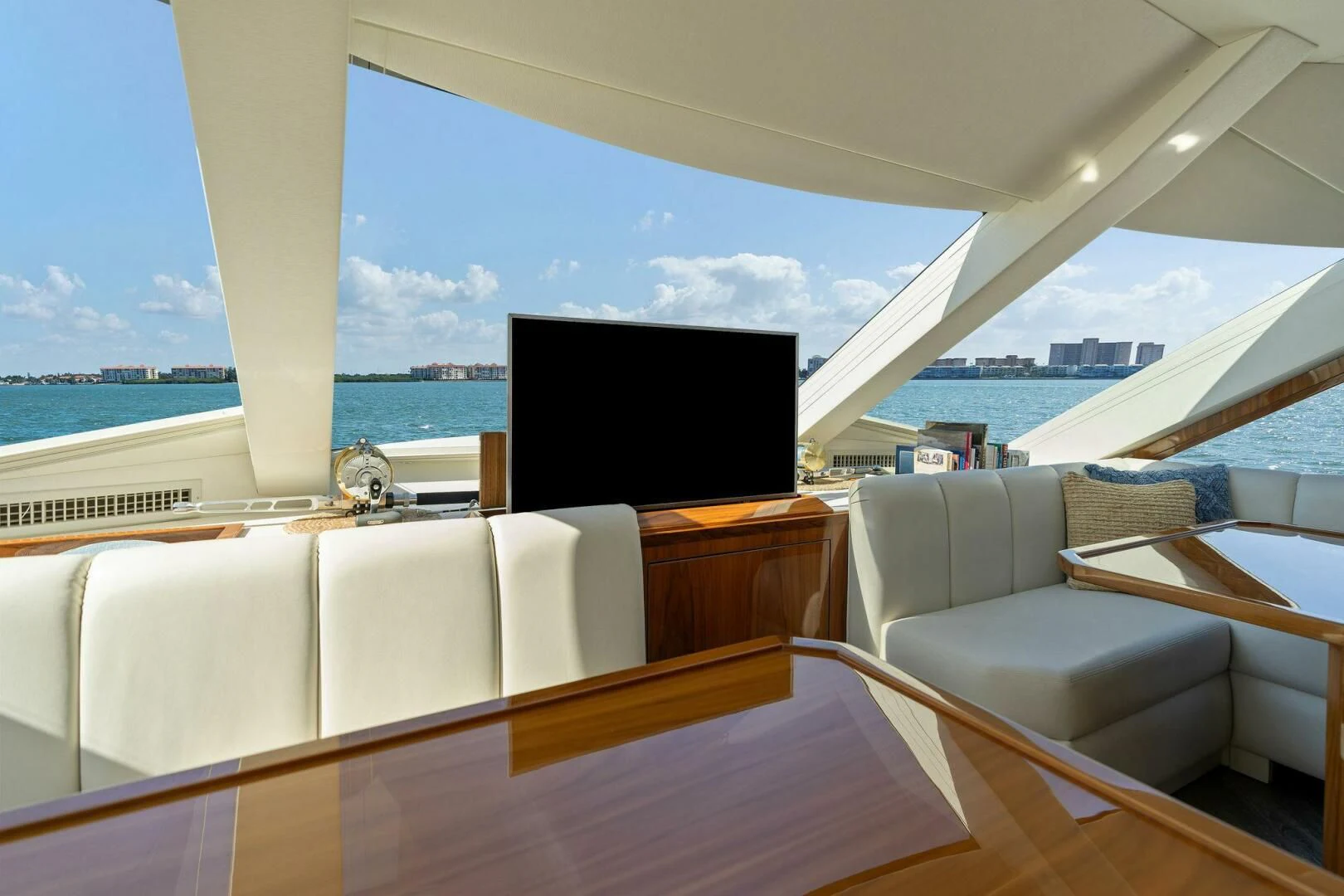a room with a large window and a tv on a stand aboard MANA Yacht for Sale