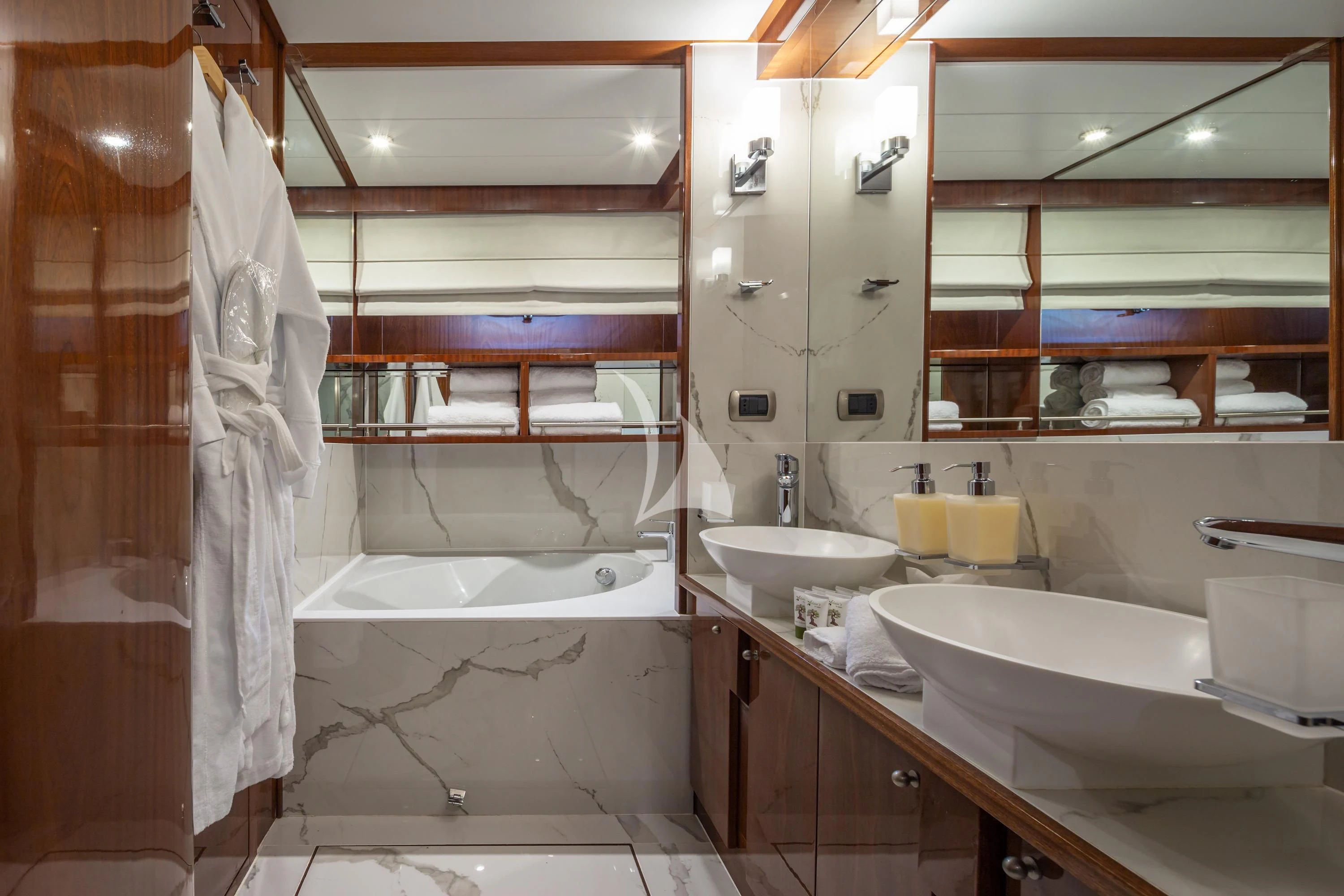 a bathroom with a tub sink and a sink aboard GRACE Yacht for Sale
