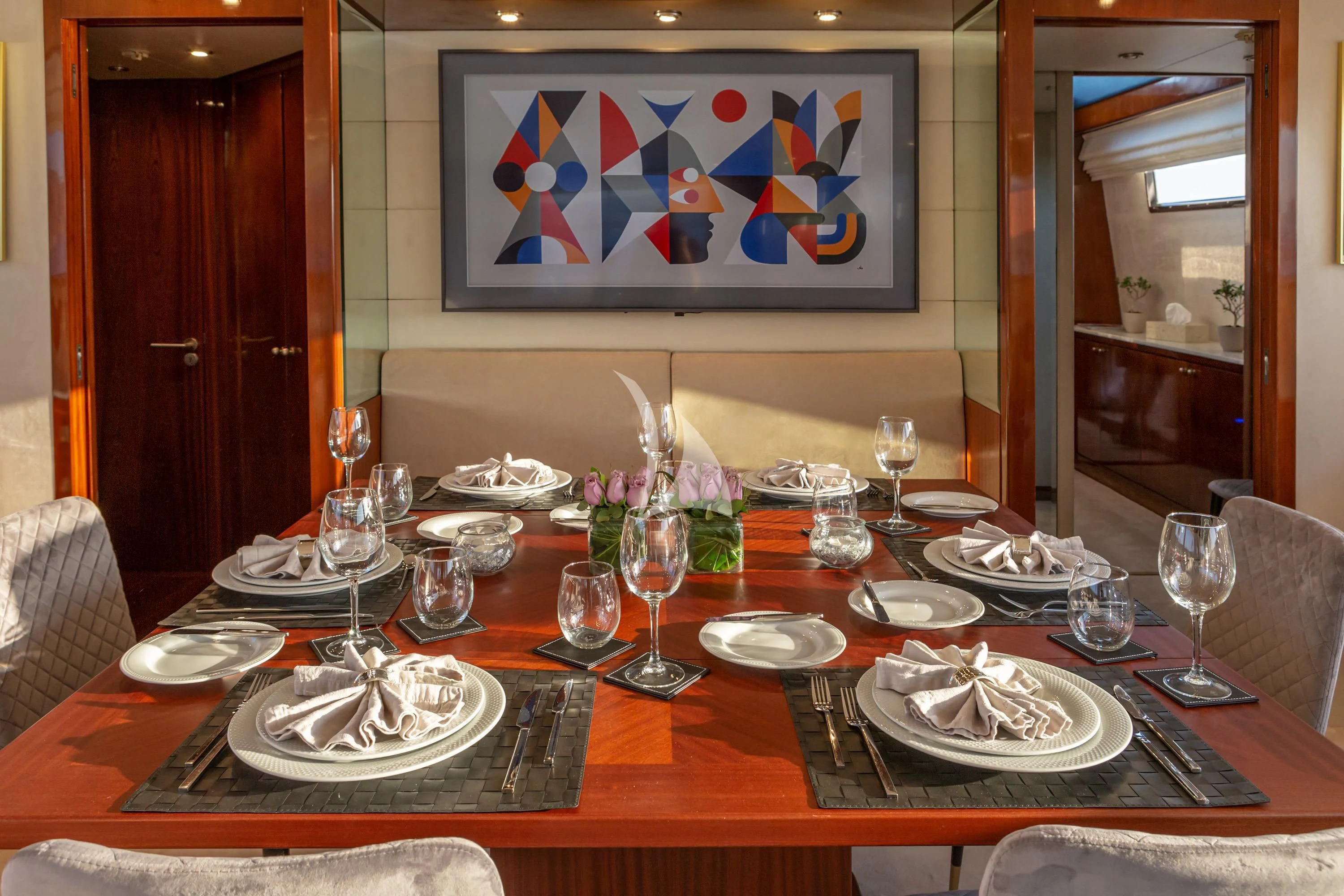 a table set with plates and glasses aboard GRACE Yacht for Sale