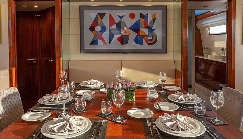 a table set with plates and glasses aboard GRACE Yacht for Sale