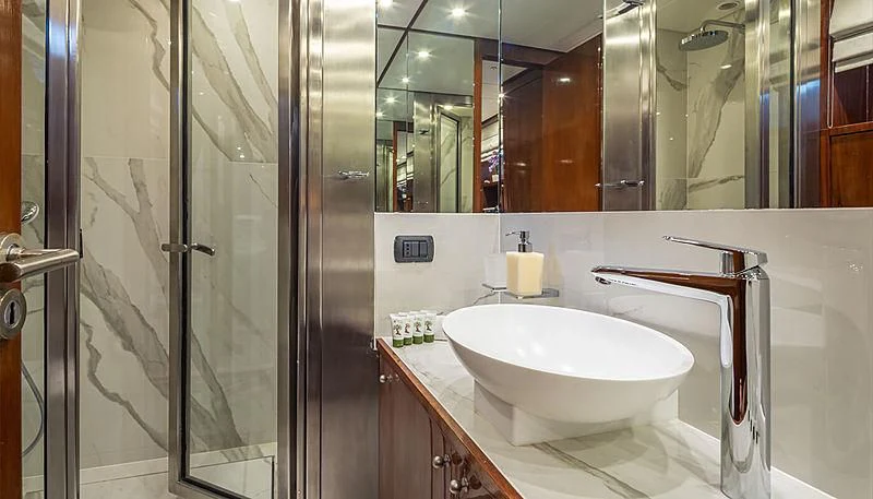 a bathroom with a sink and a mirror aboard GRACE Yacht for Sale