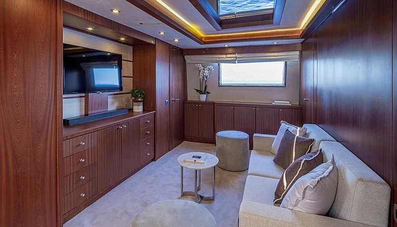 a living room with a couch and tv aboard GRACE Yacht for Sale