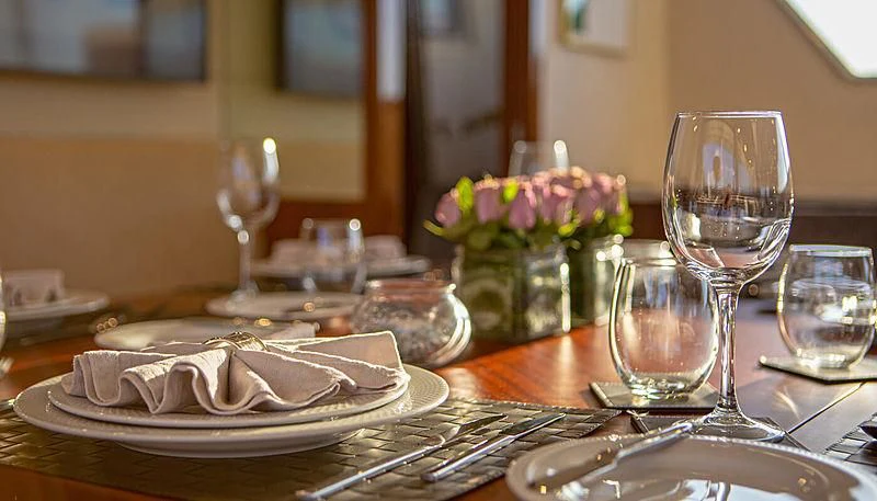 a table with plates and glasses aboard GRACE Yacht for Sale