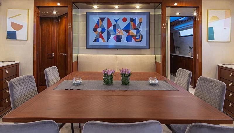 a table with a vase of flowers on it aboard GRACE Yacht for Sale