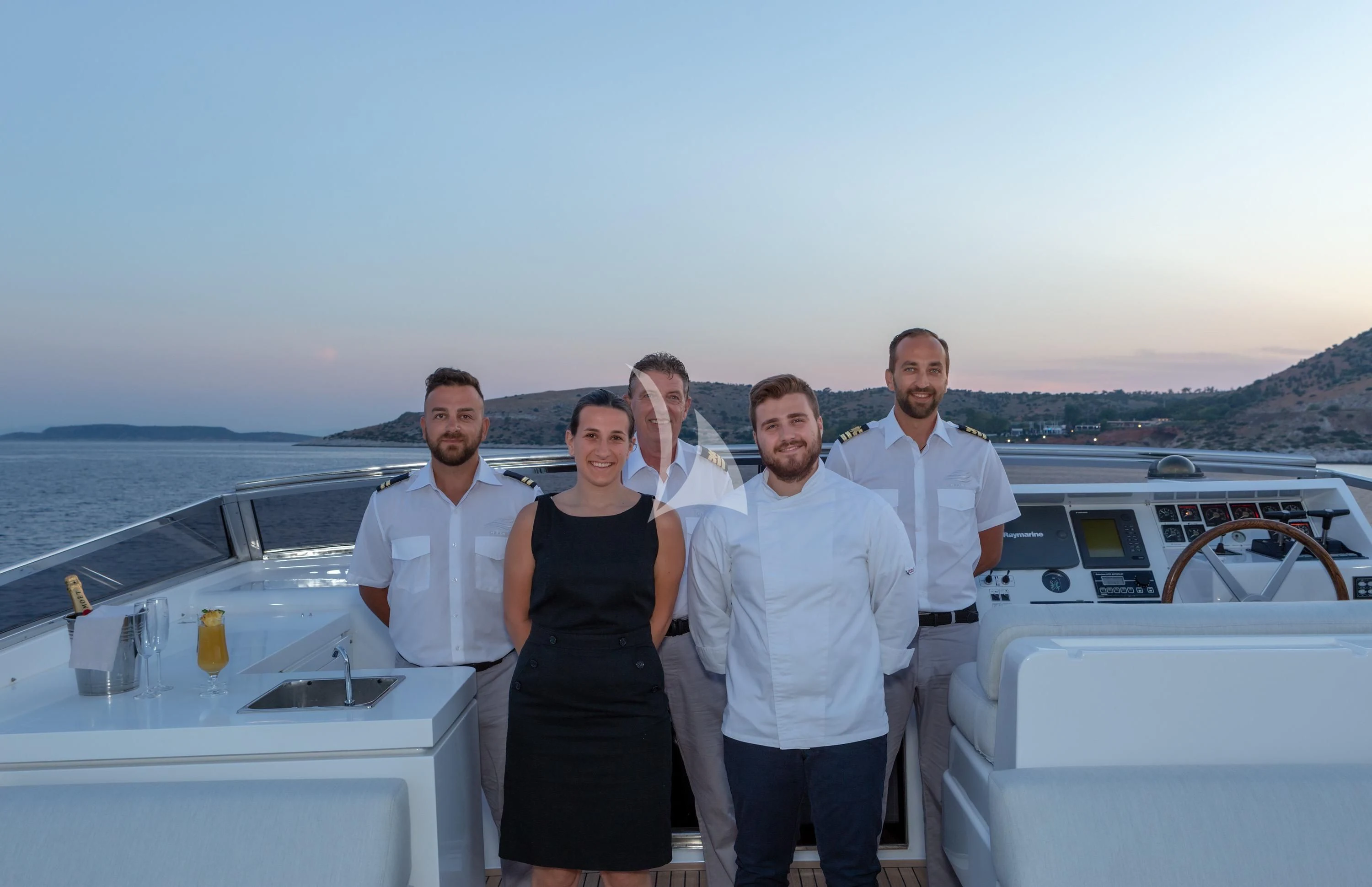 a group of people posing for a photo on a boat aboard GRACE Yacht for Sale