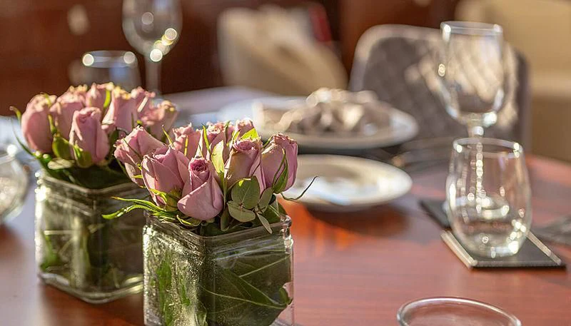 a vase of flowers on a table aboard GRACE Yacht for Sale