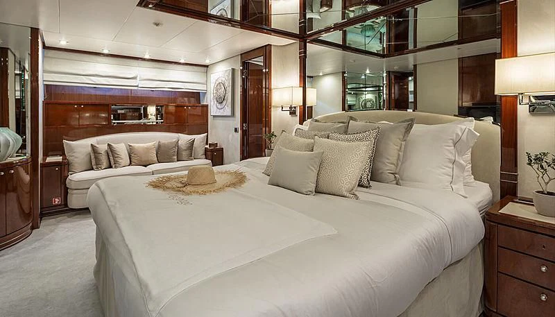 a bed with white sheets aboard GRACE Yacht for Sale