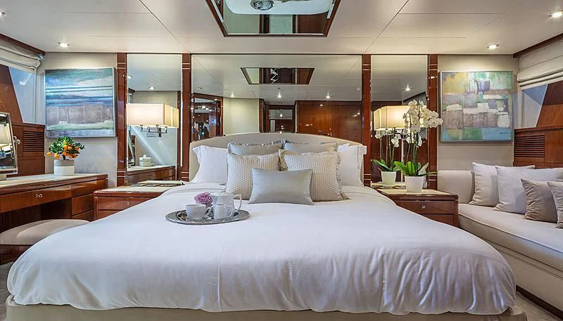 a bed with white sheets and pillows aboard GRACE Yacht for Sale