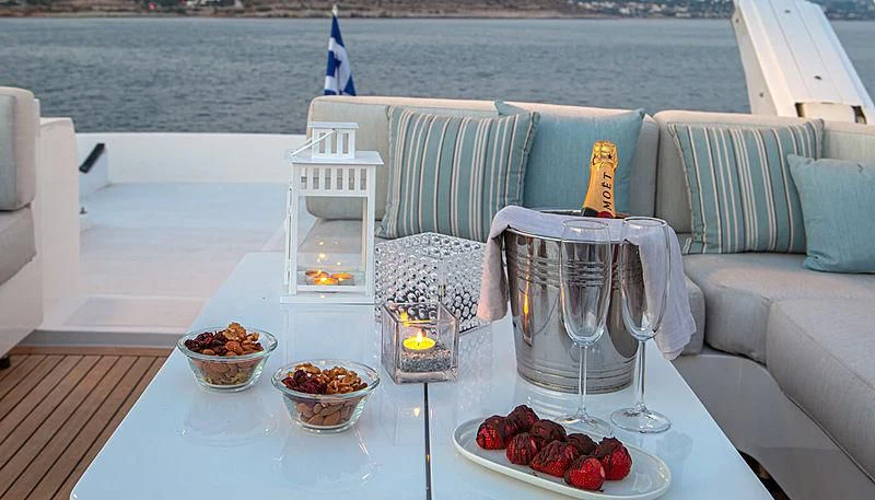 a table with food and glasses on it aboard GRACE Yacht for Sale