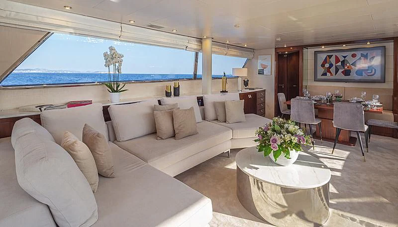 a living room with a large sofa and a table aboard GRACE Yacht for Sale