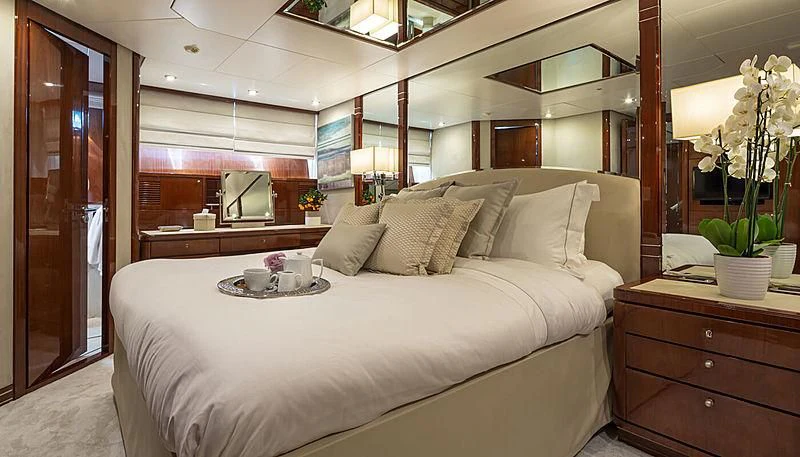 a bed with white sheets and pillows aboard GRACE Yacht for Sale
