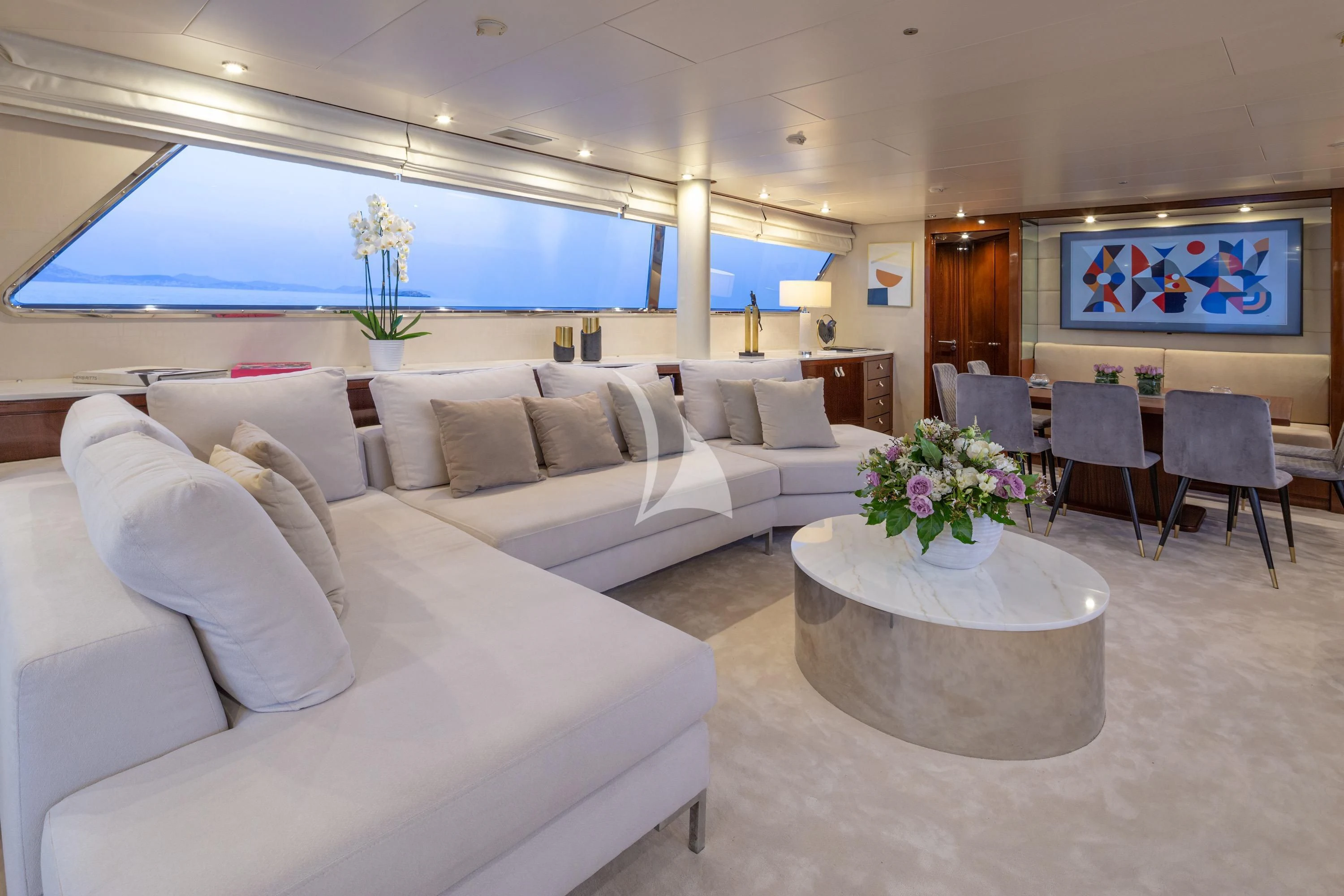 a living room with a couch and a table aboard GRACE Yacht for Sale