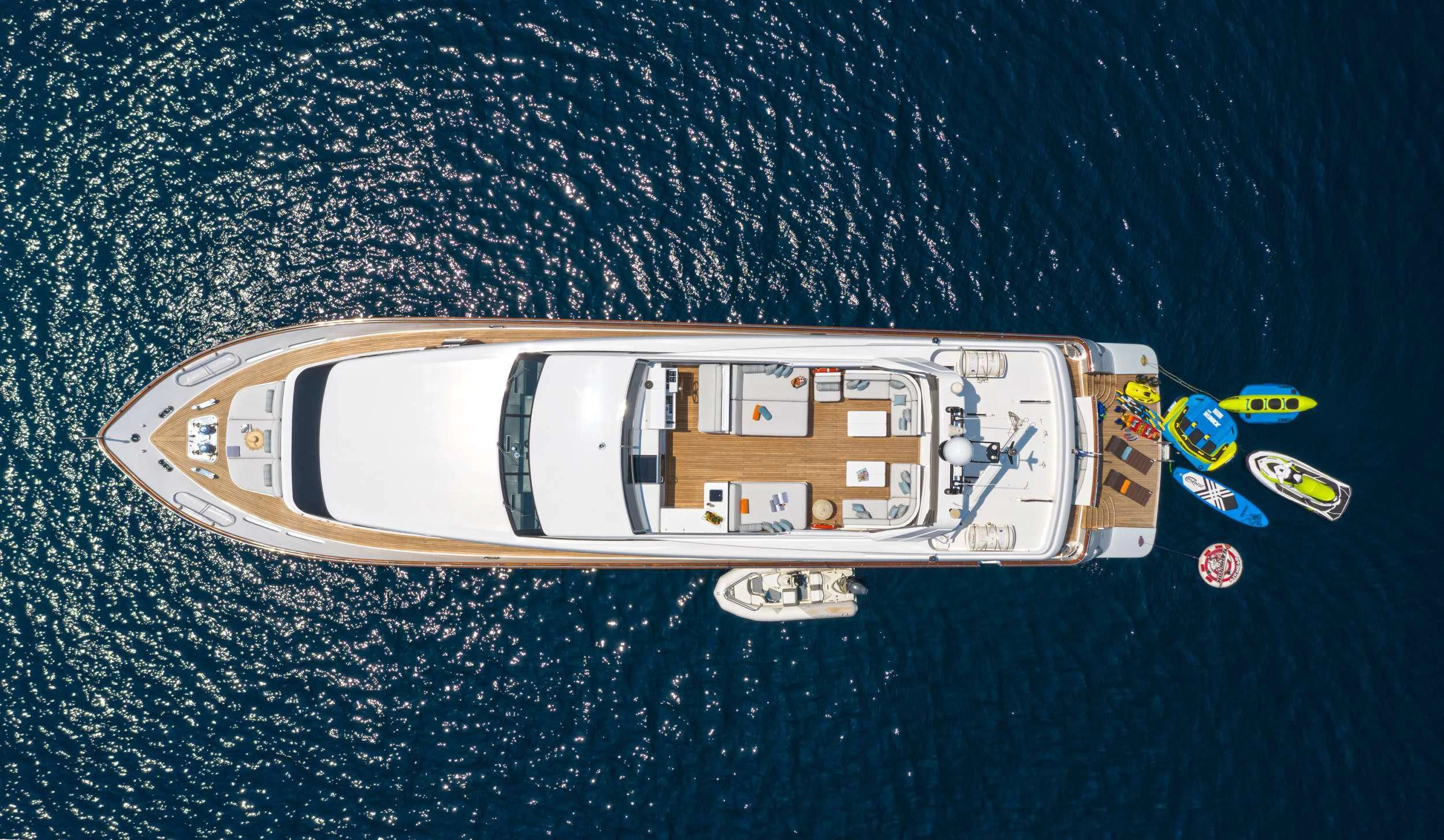 a toy ship on a blue surface aboard GRACE Yacht for Sale