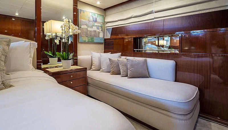 a bed with white sheets and pillows aboard GRACE Yacht for Sale