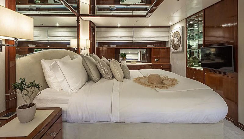 a bed with a white comforter aboard GRACE Yacht for Sale