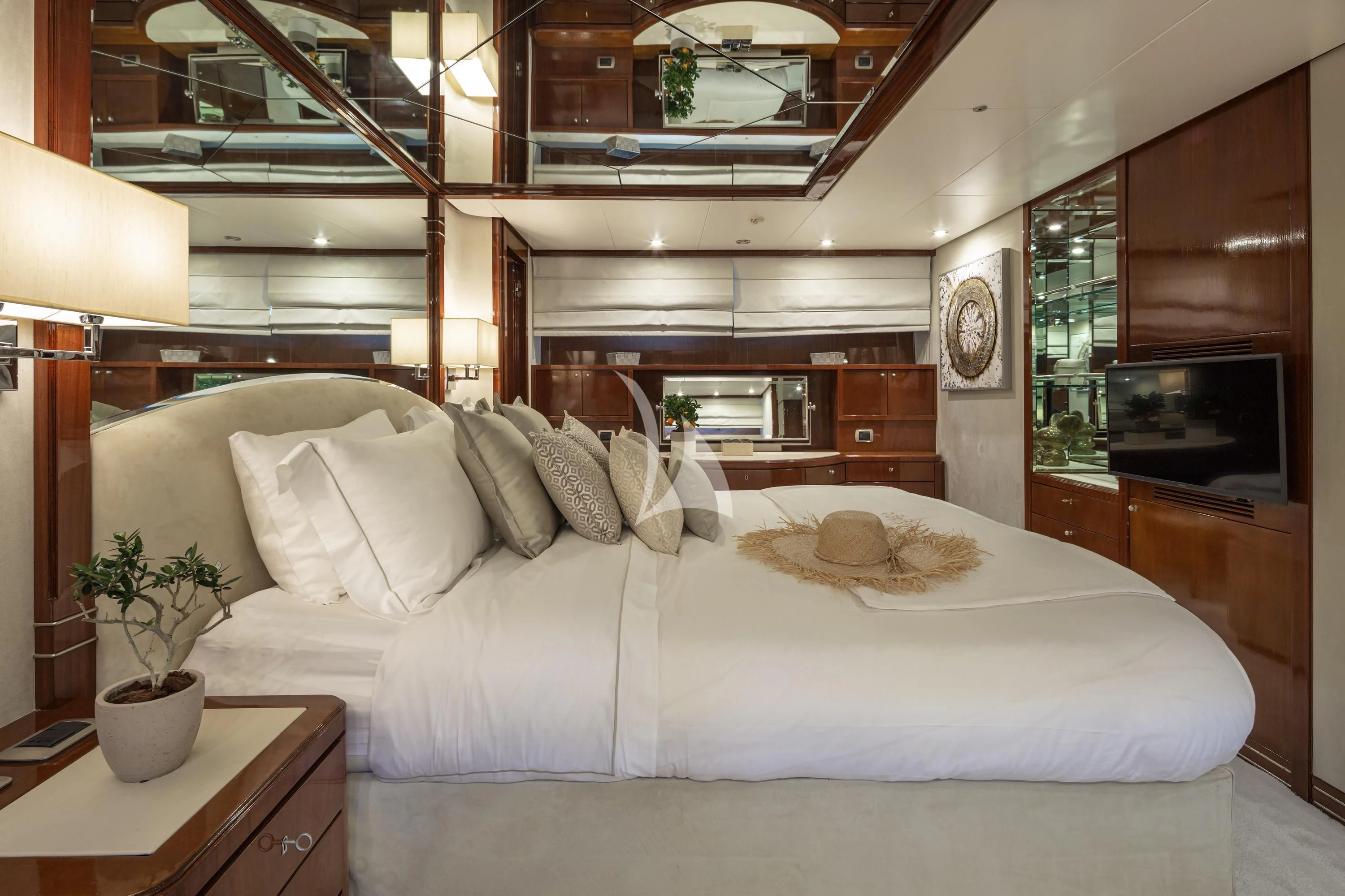 a bed with a white bed spread aboard GRACE Yacht for Sale