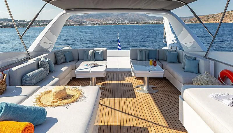 a deck with a view of the ocean and a beach aboard GRACE Yacht for Sale